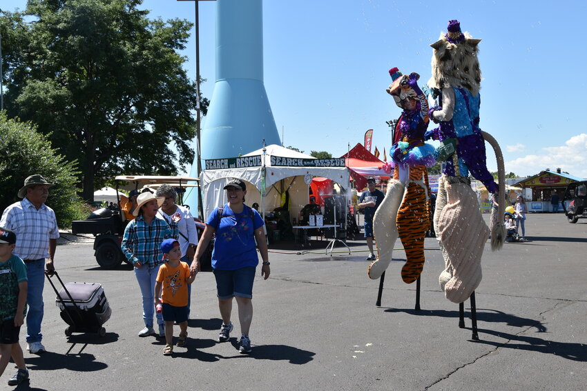 The giant puppet making families laugh as they approach them with dancing and blowing bubbles on August 3.